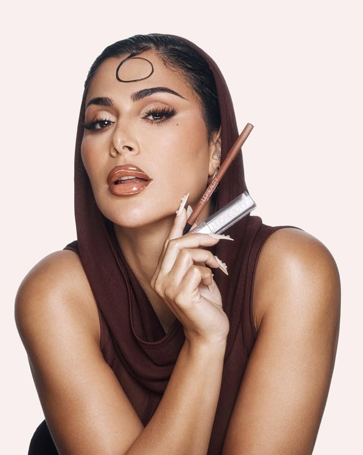 Huda Kattan Posing With Huda Beauty Products