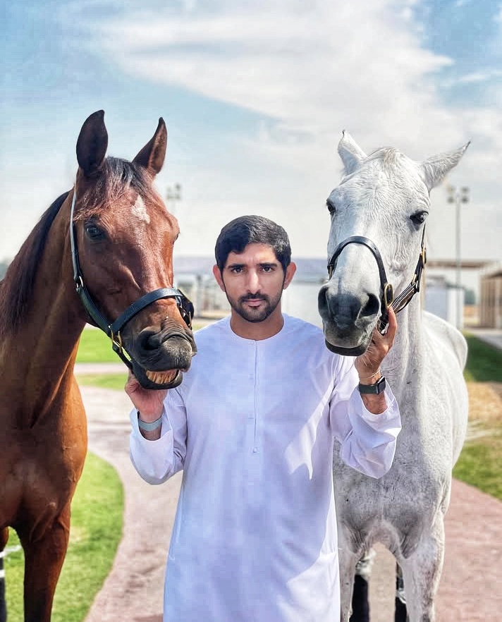 Sheikh Hamdan Bin Mohammed Al Maktoum posing with His two lovely Horse